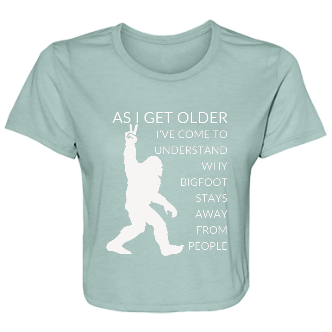 Dusty blue women's flowy cropped tee featuring Bigfoot silhouette and humorous quote 'As I get older, I've come to understand why bigfoot stays away from people' - stylish casual shirt for women 