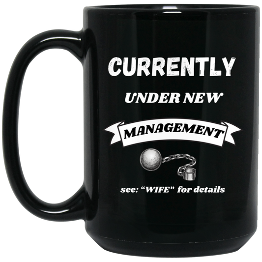 Funny 15oz black ceramic mug with “Currently Under New Management: See WIFE for Details” text and playful ball and chain graphic