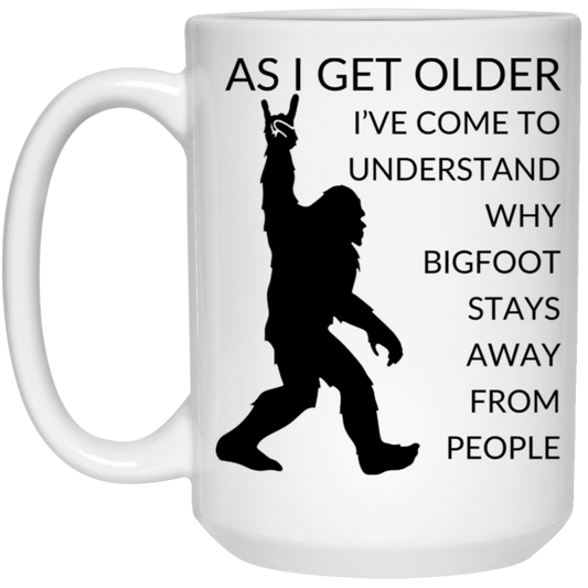 High-quality 15oz white ceramic mug featuring a silhouette of Bigfoot and the message "As I get older I've come to understand why Bigfoot stays away from people,"