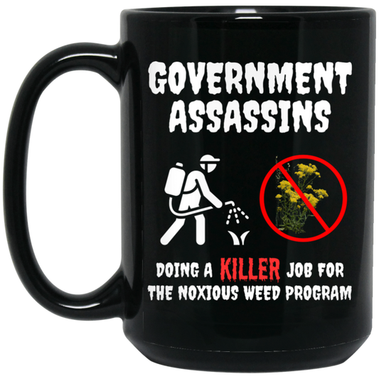 Humorous 15oz black ceramic mug featuring an herbicide applicator spraying Dyers Woad and 'Government Assassins' text – perfect gift for natural resource specialists