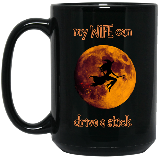 My wife can drive a stick Mug - 15oz black ceramic mug featuring a witch flying in front of a full moon with 'My wife can drive a stick' text design."